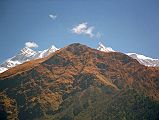 404 Annapurna  Northwest Face, Thulo Bugin, Fang From Lete Annapurna Northwest Face is visible from Lete, with the grassy slopes of Thulo Bugin, and then Fang poking up to the right. The trek to Annapurna North Base Camp goes via Thulo Bugin.